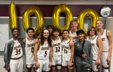 Ronnie Roche, No. 32, celebrates his 1,000th point with teammates Thursday night at Kings Christian High School. Roche is only a junior.